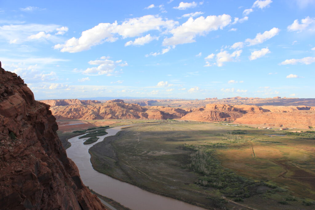 Winding Colorado River beneath red rock cliffs near Moab, Utah — a rugged, expansive landscape symbolizing the journey of transformation. The terrain evokes the spirit of PathForgeXP: forging resilience, rediscovering purpose, and living with intention as fathers and leaders. Design your life with purpose. 